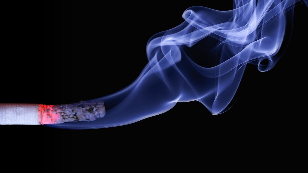A burning cigarette with smoke