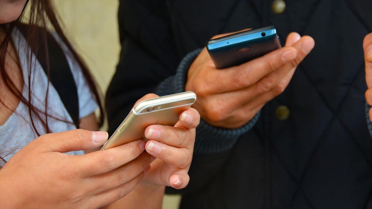 hands holding mobile phones